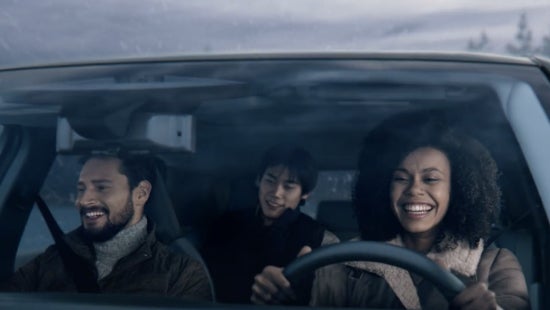 Three passengers riding in a vehicle and smiling | Fort Worth Nissan in Fort Worth TX